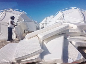 This photo provided by Jake Strang shows mattress and tents set up for attendees of the Fyre Festival, Friday, April 28, 2017 in the Exuma islands, Bahamas. Organizers of the much-hyped music festival in the Bahamas canceled the weekend event at the last minute Friday after many people had already arrived and spent thousands of dollars on tickets and travel. A statement cited "circumstances out of our control," for their inability to prepare the "physical infrastructure" for the event in the largely undeveloped Exumas. (Jake Strang via AP)