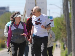 Ron Weigand, right, and supporters walk up Division Street Saturday during the Walk4PR, which stands for proportional representation (Steph Crosier/The Whig-Standard).