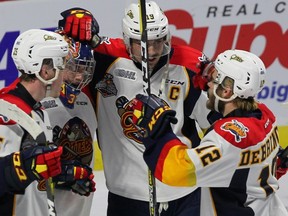 Erie Otters' TJ Fergus, left to right, Troy Timpano, Dylan Strome and Alex DeBrincat celebrate their victory over the Seattle Thunderbirds during Memorial Cup round robin hockey action in Windsor on May 20, 2017. (THE CANADIAN PRESS/Dave Chidley)