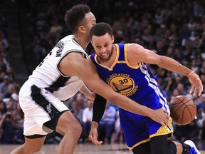 Stephen Curry, right, of the Golden State Warriors dribbles against Kyle Anderson of the San Antonio Spurs in the first half during Game Four of the 2017 NBA Western Conference Finals at AT&T Center on May 22, 2017 in San Antonio, Texas. (Photo by Ronald Martinez/Getty Images)