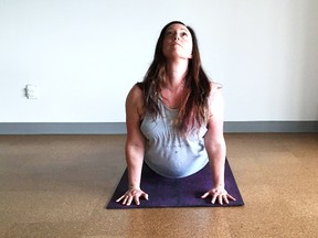 Nicole Cameron of Two Souls Yoga on Bouchard Street does an upward dog pose to finish off a sun salutation. The yoga studio is now open and they offer a variety of treatments. Learn more at twosoulsyoga.com. (Mary Katherine Keown/Sudbury Star)