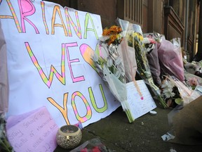 Flower tributes at St Ann's square, Manchester, England Tuesday May 23, 2017. The Islamic State group claimed responsibility Tuesday for the suicide attack at an Ariana Grande show that left more than 20 people dead as young concertgoers fled, some still wearing the American pop star's trademark kitten ears and holding pink balloons. (AP Photo/Rui Vieira)