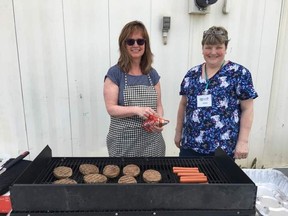 Charlene Petryshyn (left), Cause for Critters board member, and Debra Coward (right), shelter manager, were busy barbequing at the Cause for Critters new location’s grand opening but managed to pose for a photo. The grand opening was held on Thursday, May 11 starting at 5 p.m. Over 100 people attended the event.