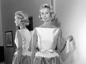 In this April 6, 1962 file photo, socialite-actress Dina Merrill models the gown she will wear at the Academy Awards presentation in Los Angeles. Merrill, the rebellious heiress who defied her super-rich parents to become an actress, died Monday, May 22, 2017, at age 93. (AP Photo/Harold P. Matosian, File)