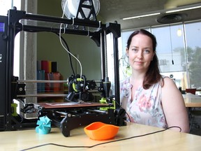 Sarah Macintyre, manager of access services at the St. Thomas Public Library, sits next to one of the library’s latest addition – a Lulzbots 3D printer. The two new printers will replace four aging models, which were no longer meeting the community’s demand for this technology, she said. (JONATHAN JUHA, Times-Journal)