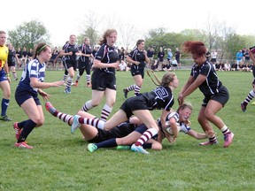 Sheridyn Van Altena is tackled while Olivia McCarter is about to hit the ruck to keep possession. (Justine Alkema/Clinton News Record)