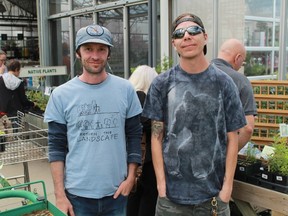 Return the Landscape's Shawn McKnight and Maajiigin Gumig species-at-risk tech Dennis Plain display a collection of native plant species taken from Aamjiwnaang First Nation, at a sale at DeGroots Nurseries on May 13.