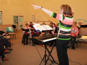 Choir director Mary Jean Hansen leads members of the recently formed community choir Synergy 150 in a run-through of John Lennon's Imagine. 
CARL HNATYSHYN/SARNIA THIS WEEK