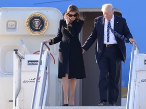 US President Donald Trump and First Lady Melania Trump step off Air Force One upon arrival at Rome's Fiumicino Airport on May 23, 2017. Donald Trump arrived in Rome for a high-profile meeting with Pope Francis in what was his first official trip to Europe since becoming US President. / AFP PHOTO / Filippo MONTEFORTEFILIPPO