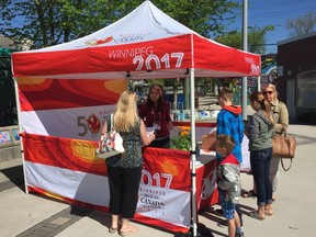 A volunteer hands out Canada Games coloured flowers at an event on Tuesday, May 23, 2017, to announce a community initiative entitled Eyes of the Nation intended to build a positive image of Winnipeg, Gimli and Kenora for the 4,000 athletes and coaches and 20,00o visitors who are expected for the 2017 Canada Summer Games. JASON FRIESEN/Winnipeg Sun/Postmedia Network