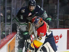 Erie Otters goalie Troy Timpano battles for the puck behind his net with Seattle Thunderbirds' Alexander True during Memorial Cup action in Windsor on May 20, 2017. (THE CANADIAN PRESS/Dave Chidley)