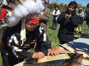 Peguis First Nation Chief Glenn Hudson signs a re-declaration of Treaty 1 First Nations Tuesday at the Kapyong lands in Winnipeg on Tuesday, May 23, 2017. David Larkins/Winnipeg Sun/Postmedia Network