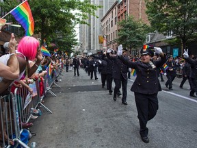 Members of New York City's Gay Officers Action League are cheered during the NYC Pride march in 2013. (AP/PHOTO)