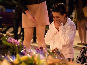 A woman is consoled as she looks at the floral tributes following an evening vigil outside the Town Hall on May 23, 2017 in Manchester, England. An explosion occurred at Manchester Arena as concert goers were leaving the venue after Ariana Grande had performed. Greater Manchester Police are treating the explosion as a terrorist attack and have confirmed 22 fatalities and 59 injured. (Photo by Leon Neal/Getty Images)