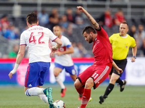 Fury FC’s Sito Seoane (right) kicks the ball past TFC’s Mitch Taintor at TD Place in Ottawa last night. (Darren Brown/Postmedia Network)
