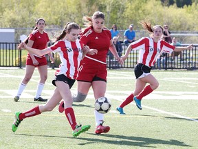 Mikayla Desrosiers of the MacDonald Cartier Panthers battles for the ball with Gabriella Alves of the St. Charles College Cardinals during senior girls high school city championship game action in Sudbury, Ont. on Tuesday May 23, 2017. Gino Donato/Sudbury Star/Postmedia Network