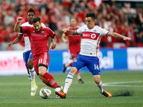 Ottawa Fury FC’s Sito Seoane tries to get by Toronto FC’s Jay Chapman during last night’s game. (DARREN BROWN/Ottawa Sun)