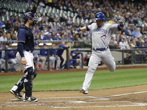 Toronto Blue Jays' Russell Martin scores past Milwaukee Brewers catcher Manny Pina during the second inning of a game on May 23, 2017. (AP Photo/Morry Gash)