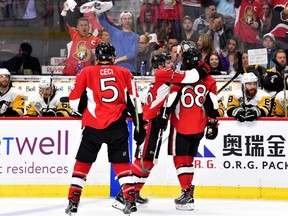 Senators forward Mike Hoffman (right) celebrates with teammate Clarke MacArthur after scoring against the Pittsburgh Penguins in the the third period of Game 6 on Tuesday night. MacArthur picked up an assist on the goal. (Getty Images)