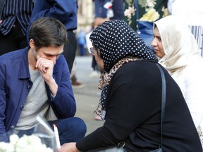 Mourners gather to console each other in the aftermath of terrorist attack at Ariana Grandein Manchester, United Kingdom. WENN.com