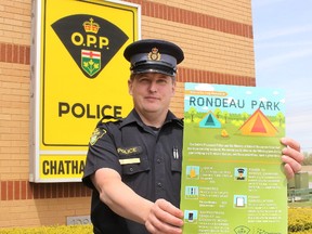 Chatham-Kent OPP Const. Jay Denorer is pictured with a poster that has been placed in area high schools outlining the rules and consequences of breaking those rules to local young people planning on camping at Rondeau Provincial Park during the upcoming Victoria Day long weekend.