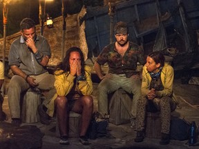 In this image released by CBS, contestants, from left, Jeff Varner, Sarah Lacina, Zeke Smith and Debbie Wanner appear at the Tribal Council portion of the competition series "Survivor: Game Changers." Smith was outed as transgender by fellow competitor Varner.
