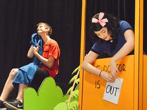 Lucy (Samantha DeGroot), right, adjusts her psychiatry sign before a dress rehearsal of You're a Good Man Charlie Brown while behind her, Linus (Elliot Smith) hangs on to his trusty blanket. They're both starring in the upcoming CCS musical later this week.