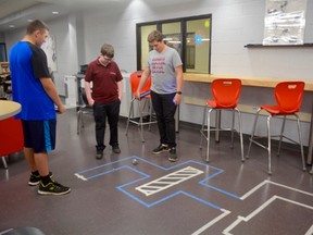 Tyson Rousseau, Bradlee Renton and Erich Zappel created a path which their Sphere-O bot follows based on the math and speed analysis the students have developed on their iPad, during the recent IGNITE Technology Fair that took place at St. Charles College last Thursday. Photo supplied