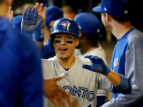 Ryan Goins of the Toronto Blue Jays celebrates with teammates after hitting a grand slam in the sixth inning against the Milwaukee Brewers at Miller Park on May 24, 2017. (Dylan Buell/Getty Images)