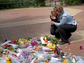 People react on Wednesday, May 24, 2017 as they lay flowers in the centre of the Lancashire village of Tarleton, the home village of Georgina Callander, 18, and Saffie Rose Roussos, 8, who were killed in the Manchester attack. (GETTY IMAGES/PHOTO)