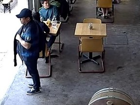 Surveillance footage of a suspected purse snatcher.