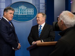 Fox News television personality and political commentator Sean Hannity (left) speaks with White House Press Secretary Sean Spicer in the James Brady Press Briefing Room at the White House, January 24, 2017 in Washington, DC. (Photo by Drew Angerer/Getty Images)