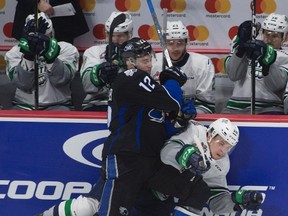 Saint John Sea Dogs right winger Julien Gauthier sends Seattle Thunderbirds right winger Sami Moilanen into the boards during Memorial Cup action in Windsor on May 23, 2017. (THE CANADIAN PRESS/Adrian Wyld)