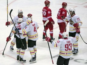 Kunlun Red Star's team players celebrate after scoring a goal during a Kontinental Hockey League match against Spartak Moscow in Moscow on Oct. 1, 2016. (THE CANADIAN PRESS/AP/Pavel Golovkin)