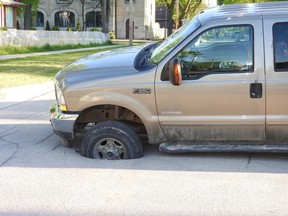 Farley Pollack's truck was the victim of a sinkhole near Bannerman Avenue and Powers Street Wednesday night. (James Carter/Submitted)