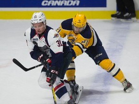 Spitfires defenceman Mikhail Sergachev skates past Erie Otters left wing Patrick Fellows during their game last night in Windsor. The Spits’ Russian blueliner says his dad doesn’t like his habit of cracking wise with reporters. (The Canadian Press)
