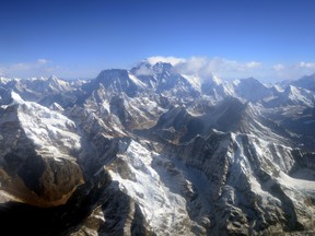 This photograph taken from an aircraft shows an aerial view of Mount Everest (C) and The Himalayan mountain range, some 140kms (87 miles) north-east of Kathmandu on April 3, 2013. AFP PHOTO/Prakash MATHEMA
