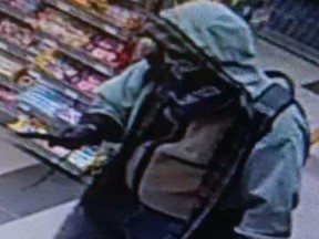 A suspect brandishes a knife in a holdup in a gas bar in Pembroke Tuesday.