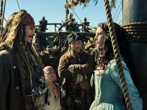 In this image released by Disney, Johnny Depp portrays Jack Sparrow, left, and Kaya Scodelario portrays Carina Smyth, right, in a scene from "Pirates of the Caribbean: Dead Men Tell No Tales." (Peter Mountain/Disney via AP)