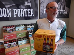 Arcadia Brewing Company founder Time Surprise shows off one of the variety packs available at his Kalamazoo location. (Kevin Hann/Toronto Sun)