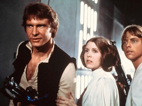 This 1977 publicity photo provided by 20th Century-Fox Film Corporation shows, from left, Harrison Ford, Carrie Fisher, and Mark Hamill in a scene from the film, "Star Wars," released by 20th Century-Fox. (AP Photo/20th Century-Fox Film Corporation)