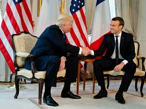 U.S. President Donald Trump shakes hands with French President Emmanuel Macron at the U.S. ambassador’s residence in Brussels, Thursday, May 25, 2017. (AP Photo/Peter Dejong, Pool)