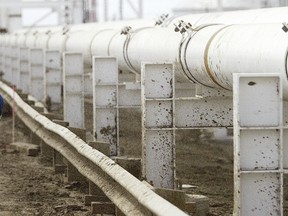 A worker walks along a new pipeline at the Enbridge facility in the east of Edmonton. (Stuart Gradon/Postmedia News)