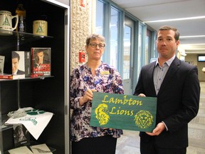 Lambton College library technician Kathi Vandenheuvel and Marc Gilbeault, director of the Lambton College Foundation and Alumni Association, show off some of the college memorabilia currently on display at its Sarnia campus. Lambton College recently put out a call on social media for more donations of memorabilia in light of its 50th anniversary. (Barbara Simpson/Sarnia Observer)