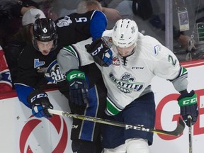 Seattle Thunderbirds defenceman Austin Strand knocks Saint John Sea Dogs defenceman Thomas Chabot off the puck during Memorial Cup action in Windsor on May 23, 2017. (THE CANADIAN PRESS/Adrian Wyld)