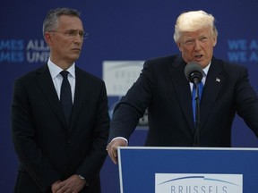 NATO Secretary General Jens Stoltenberg listens as U.S. President Donald Trump speaks during a ceremony to unveil artifacts from the World Trade Center and Berlin Wall for the new NATO headquarters in Brussels on Thursday, May 25, 2017. (Evan Vucci/AP Photo)