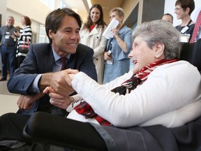 Ontario Minister of Health and Long-Term Care Eric Hoskins talks to Providence Care inpatient Bridgette MacDonald prior to the official opening of the new hospital on Thursday. (Elliot Ferguson/The Whig-Standard)