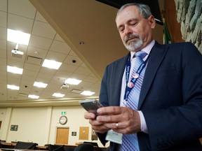 Luke Hendry/The Intelligencer
Hastings County chief administrative officer Jim Pine holds his mobile phone after a council meeting Thursday in Belleville. He's also co-leader of the Eastern Ontario Regional Network, which aims to prepare the region for the arrival of ultra-fast 5G telecommunications networks.