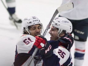 Windsor Spitfires defenceman Jalen Chatfield congratulates centre Julius Nattinen on his goal against the Seattle Thunderbirds during Memorial Cup action in Windsor on May 21, 2017. (Adrian Wyld/The Canadian Press via AP)