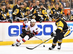 Mike Hoffman of the Ottawa Senators skates with the puck against Matt Cullen of the Pittsburgh Penguins during Game 7 at PPG Paints Arena on May 25, 2017. (Jamie Sabau/Getty Images)